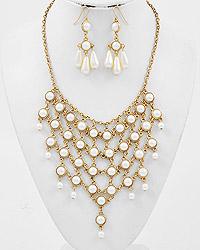 gold tone bib style necklace with pearls, and dangle earrings